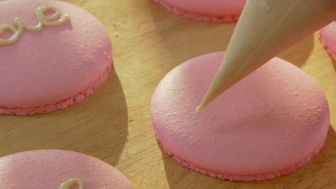 Close-up on a pink macaroon biscuits. Decorate using a pastry bag Stock Footage 71291869