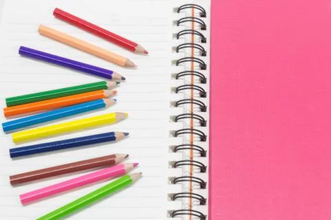 Close-up of pink orange note book and colored pencils, student drawing Stock Photos