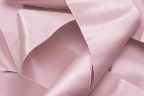 Close up of pink  silk Ribbons On Background, wavy pattern like flower Stock Photos