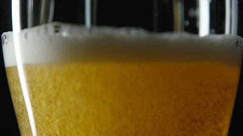 Close up pint glass being filled with golden beer Stock Footage 93561981