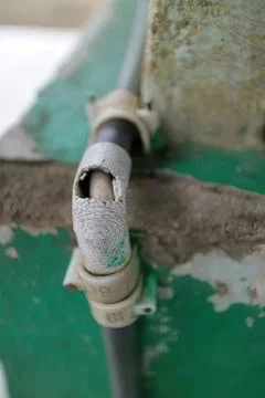 Close-up of a pipe connection on a building wall Stock Photos