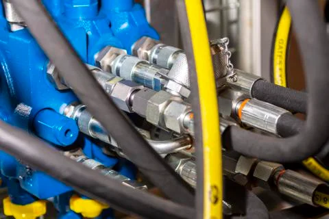 Close up of pipe system of hydraulic valves in agricultural machinery Stock Photos