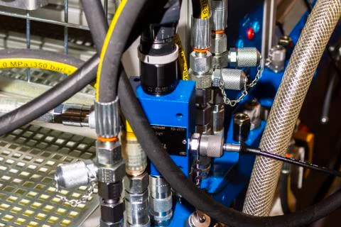 Close up of pipe system of hydraulic valves in agricultural machinery Stock Photos