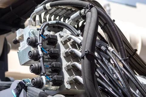 Close up of pipe system of hydraulic valves in agricultural machinery Stock Photos