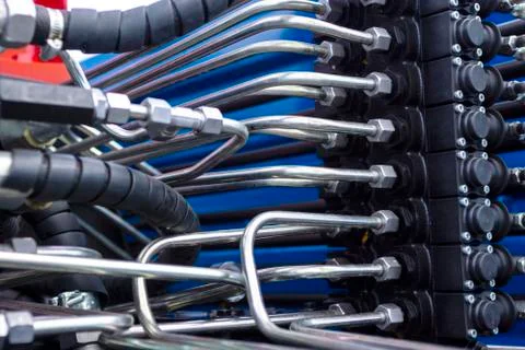 Close up of pipe system of hydraulic valves in agricultural machinery Stock Photos