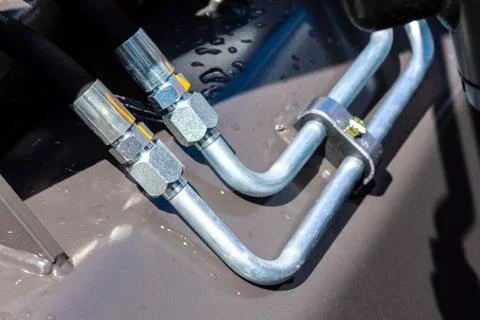 Close up of pipe system of hydraulic valves in agricultural machinery Stock Photos
