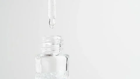 Close up of pipette and the transparent serum with blue granules in bottle... Stock Footage 259281160