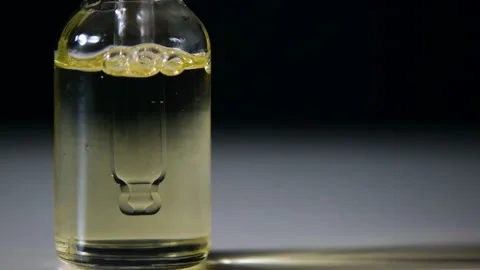 Close up of pipette inside the serum bottle with air bubbles flying up in gel Stock Footage 151826353
