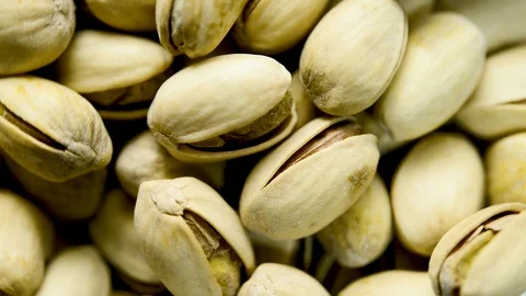 Close up of pistachio nuts rotating. Flat plane. Top view Stock Footage 104789714