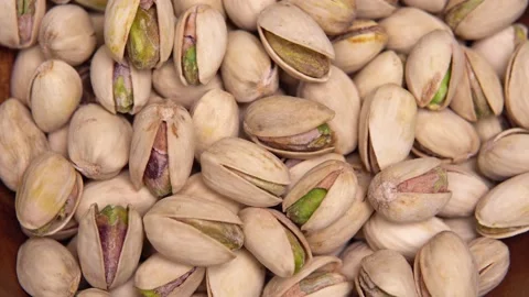 Close-up of pistachio nuts rotating on the table Stock Footage 169329546