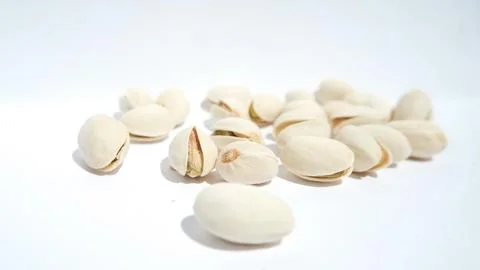 Close up of pistachios on white background Stock Photos