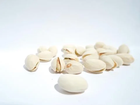 Close up of pistachios on white background Stock Photos