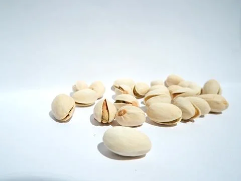 Close up of pistachios on white background Stock Photos