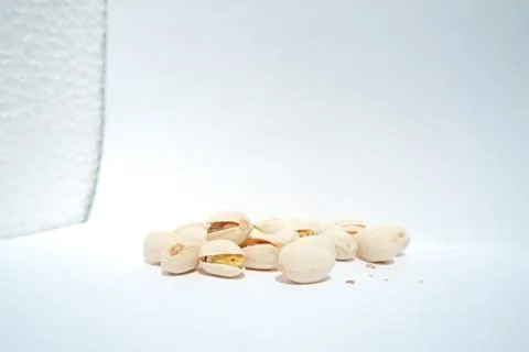 Close up of pistachios on white background Stock Photos