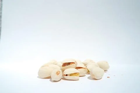 Close up of pistachios on white background Stock Photos