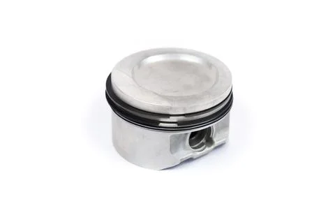 A close-up piston of an internal combustion engine with piston rings isolated on Stock Photos