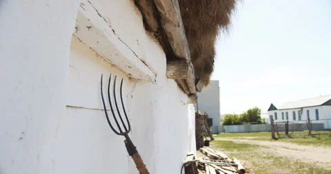 Close up. Pitchfork stands against the white wall of a village house Stock Footage 141783387