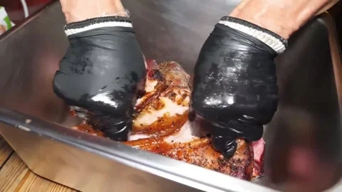 Close-up of Pitmaster Shredding Juicy Smoked BBQ Pulled Pork in Metal Pan Stock Footage 338212778
