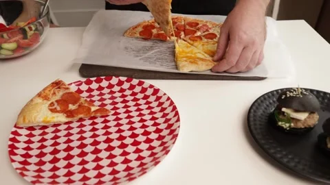 A close-up of a pizza being served, accompanied by black sesame sliders and.. Stock Footage 292621368