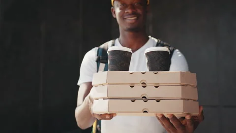 Close up pizza box. Young african delivery man in white uniform with pizza boxes Stock Footage 172217382