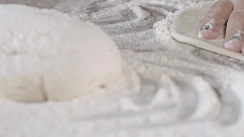 Close up of a pizza chef's hands kneading the dough to prepare a gourmet pizza. Stock Footage 124877517