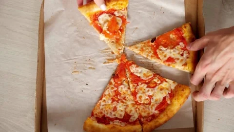 Close up pizza hand taking slice of pizza in wood dish on wooden table. Video stock 336586713