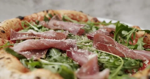 Close Up Pizza with prosciutto parma ham, arugula salad rocket with ingredients Stock-Footage 203241642