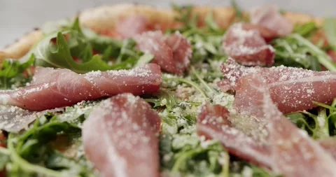 Close Up Pizza with prosciutto parma ham, arugula salad rocket with ingredients Vídeos de archivo 208010498
