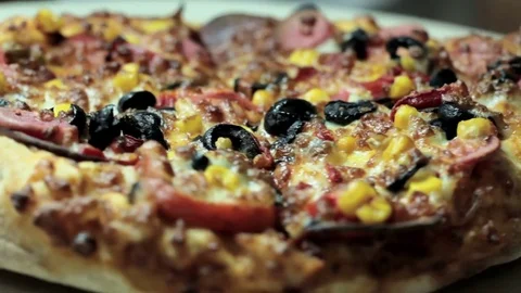 Close up pizza rotating on table, from above, top view Stock-Footage 75615842