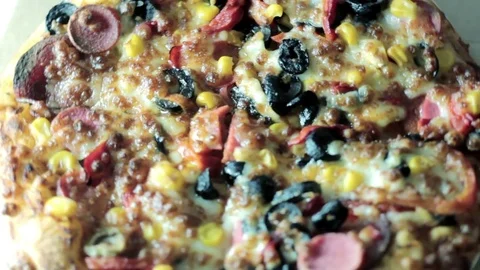 Close up pizza rotating on table, from above, top view Stock Footage 75615847