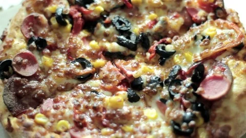 Close up pizza rotating on table, from above, top view Stock Footage 75615856