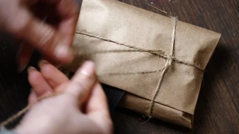 Close-Up Placing Leather Piece Under Knot on Wrapped Wallet Stock Footage 315528949