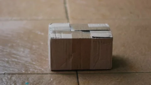 Close up of placing a small box or package Stock Footage 327788183