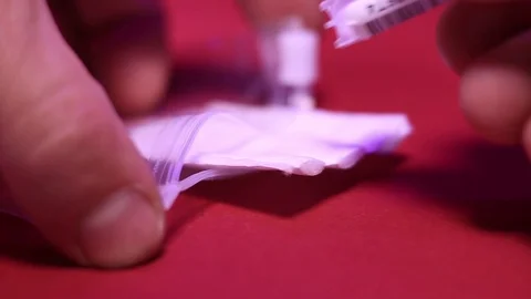 Close-up of placing two vials into biohazard plastic bag. Stock Footage 113055011