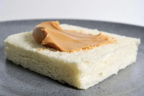 Close up plain toast with peanut butter from side angle Stock Photos