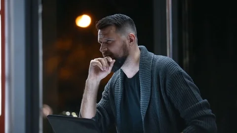 Close plan of  bearded smiling businessman  sitting in a street with his laptop 스톡 동영상 117472069