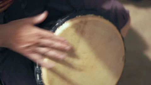 A Close-up Plan, A Man Holds a Drum With His Feet And Playing It On A Musical Stock Footage 95206119