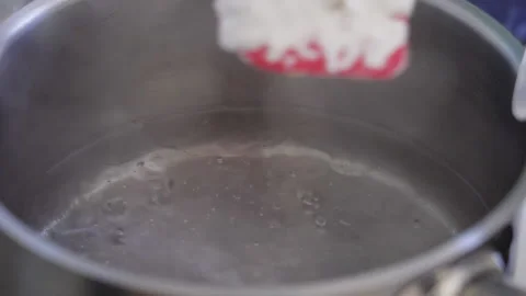 Close Plan, Slow Motion, Dry Milk Pours Into Boiling Water Stock Footage 136777399