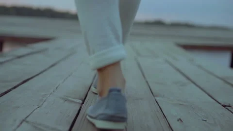 Close Plan, Slow Motion, Legs of a Woman Walking on wooden pier on the River Stock Footage 142660243