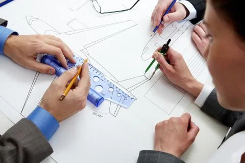 Close-up of a plane draft being measured by engineers Stock Photos