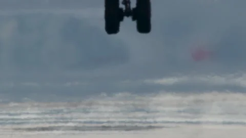 Close-Up of Plane Tire Touching Down in Slow Motion with Puff of Smoke Stock Footage 254425488