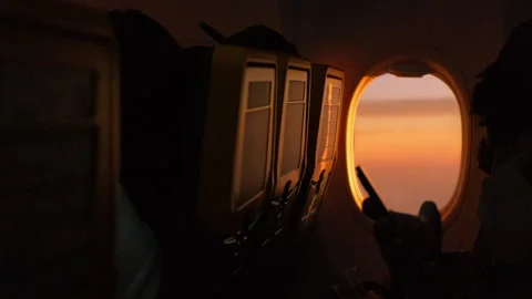 Close-up of a plane window with sunset, taken from the cabin Stock Footage 247739645