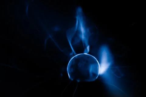 Close-up of a plasma ball globe glowing with blue and purple light and ener.. Stock Photos