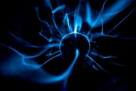 Close-up of a plasma ball globe glowing with blue and purple light and ener.. Stock Photos