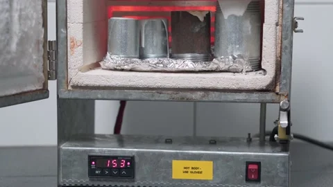 Close up, plaster molds are heated in a jewelry oven. Stock Footage 153547293