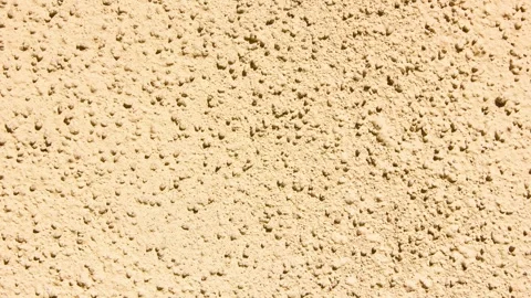 Close-up of a plastered wall, rough surface. Orange grunge wall,animation Stock Footage 340795493