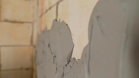 Close up of plasterer applying fresh concrete plaster on a wall during Stock Footage 345537461