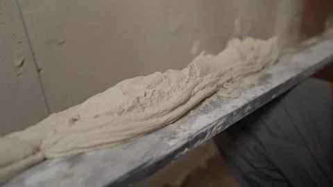 Close up of plastering joint compound on metal hawk tool Stock Photos
