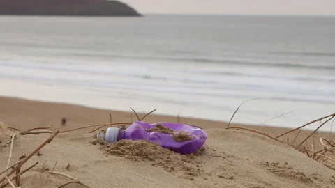 Close up of plastic bottle litter on Woolacombe beach in Devon, UK Stock Footage 170304051