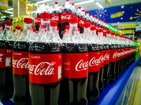 Close-up of plastic bottles with a Coca-Cola drink in a hypermarket on sale from Stock Photos